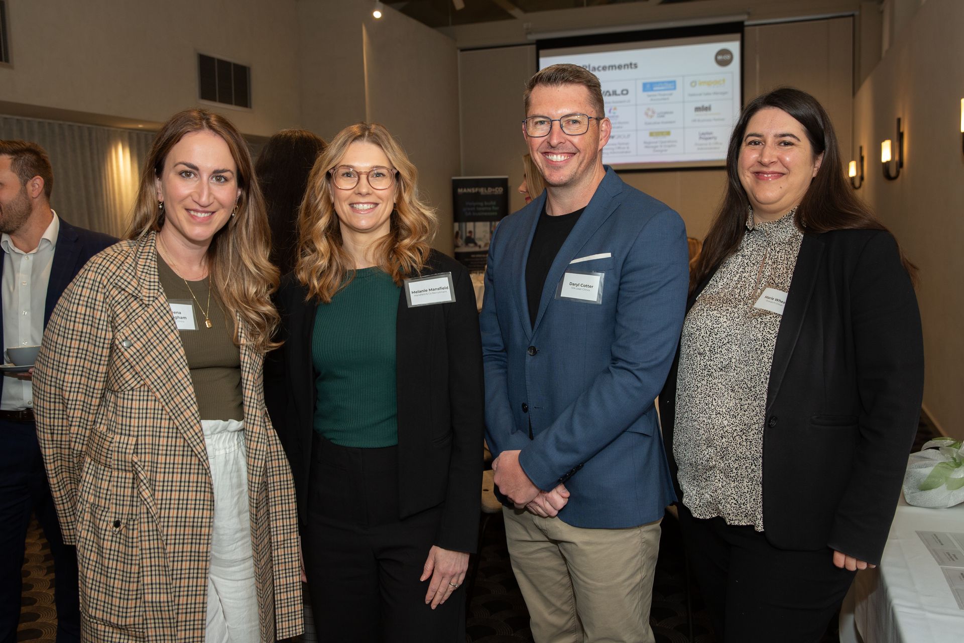 A group of people are posing for a picture in a room.