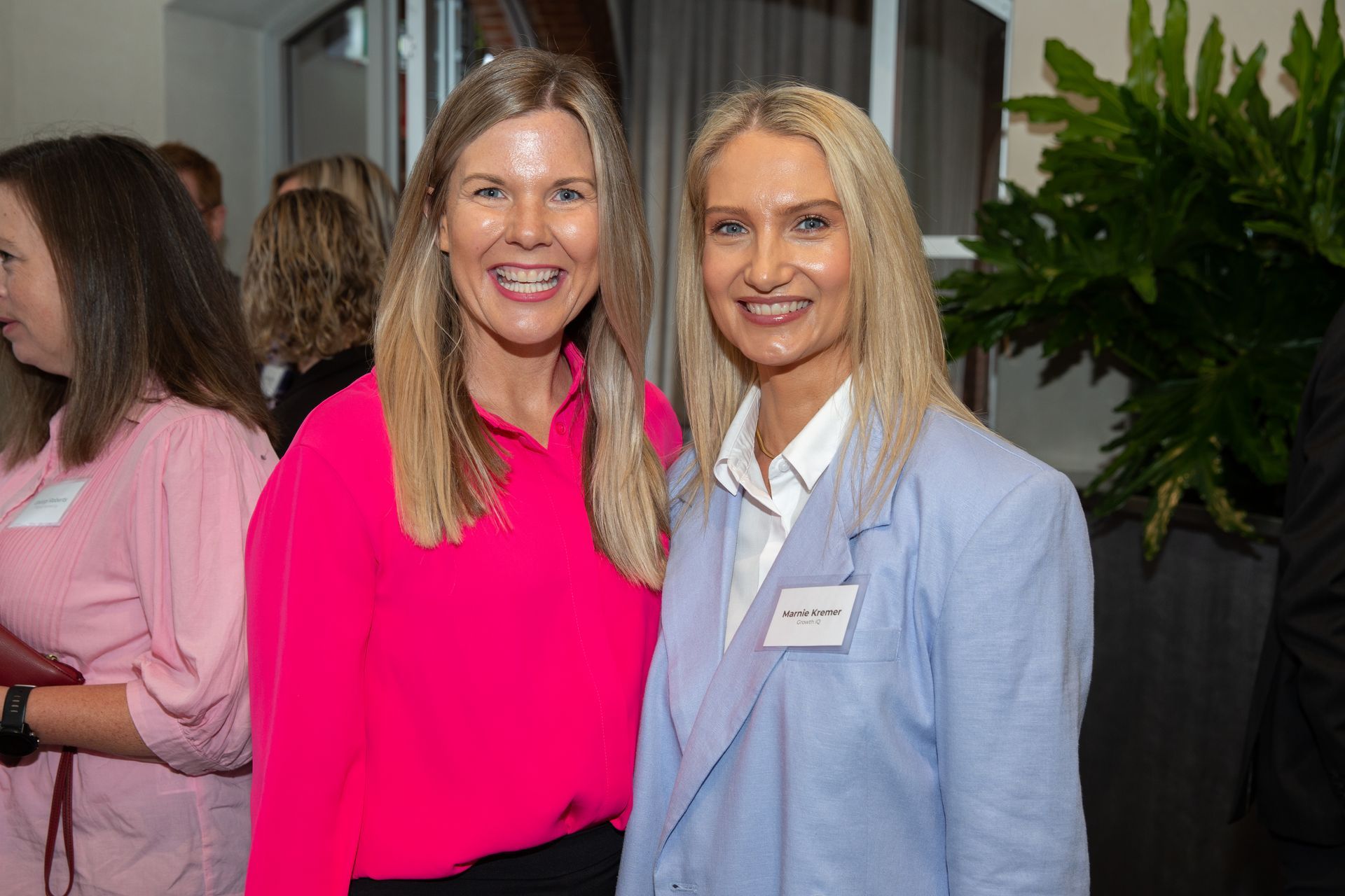 Two women are posing for a picture together at a party.