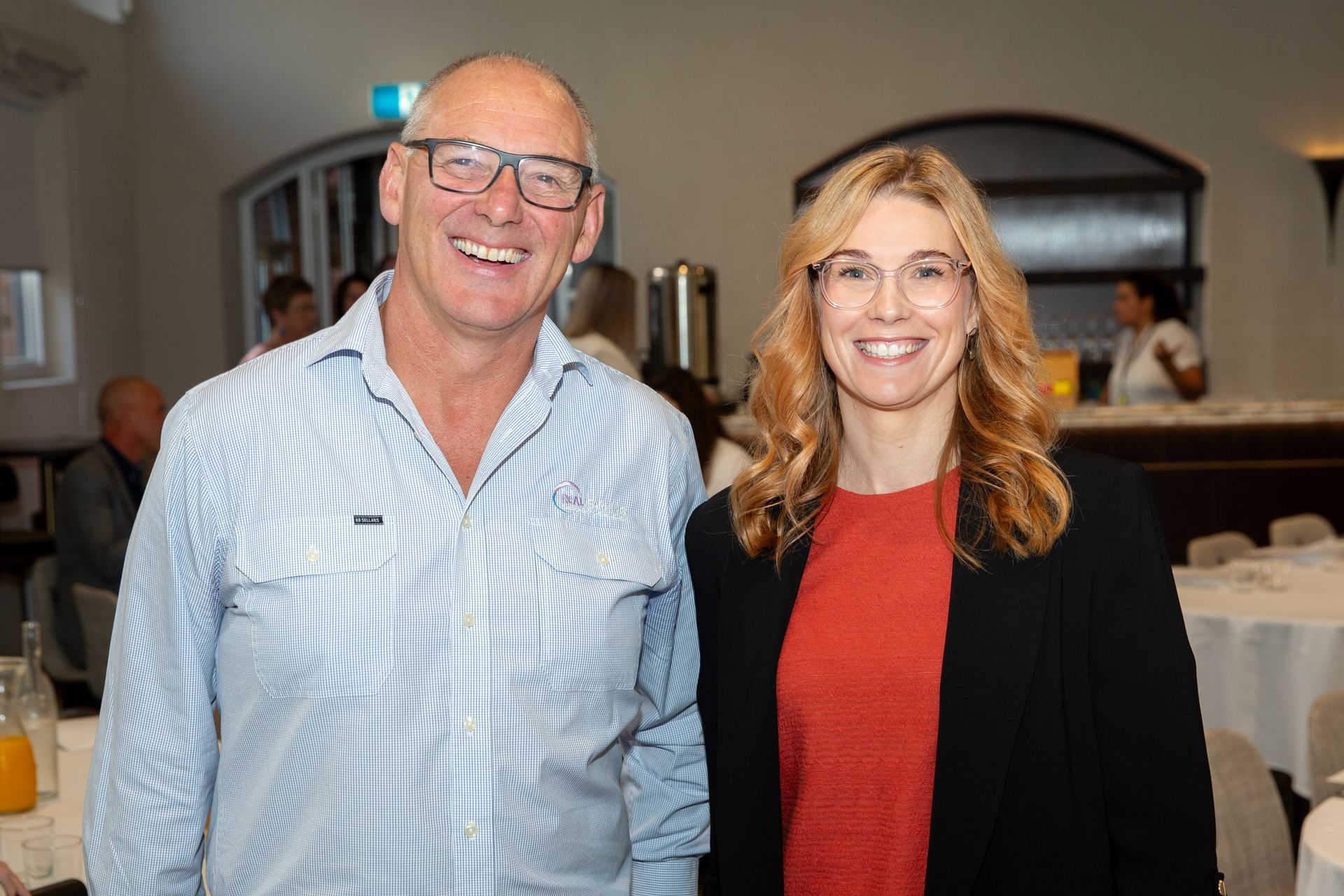 A man and a woman are posing for a picture in a room.