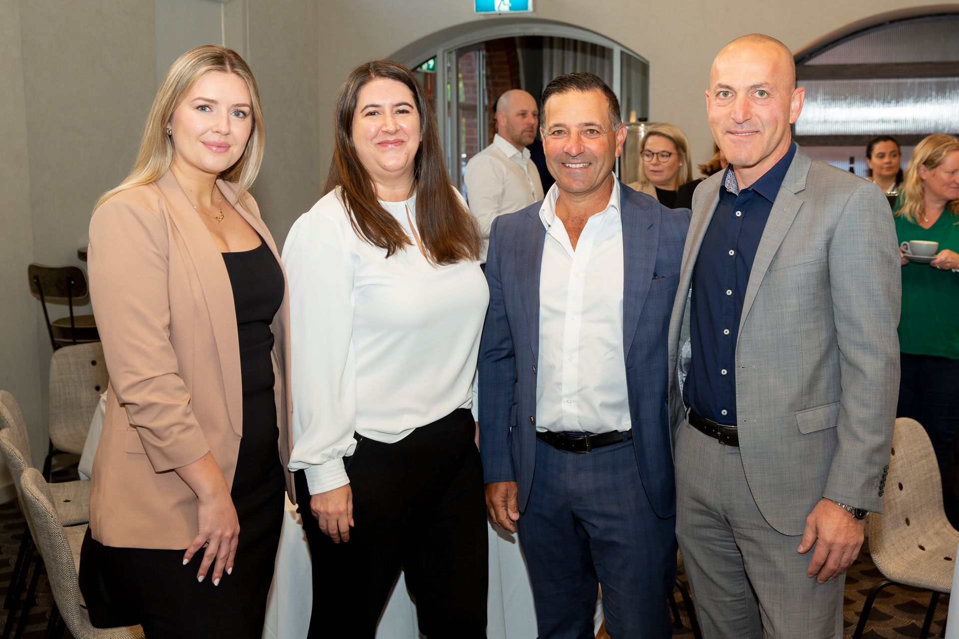 A group of people are posing for a picture together in a room.