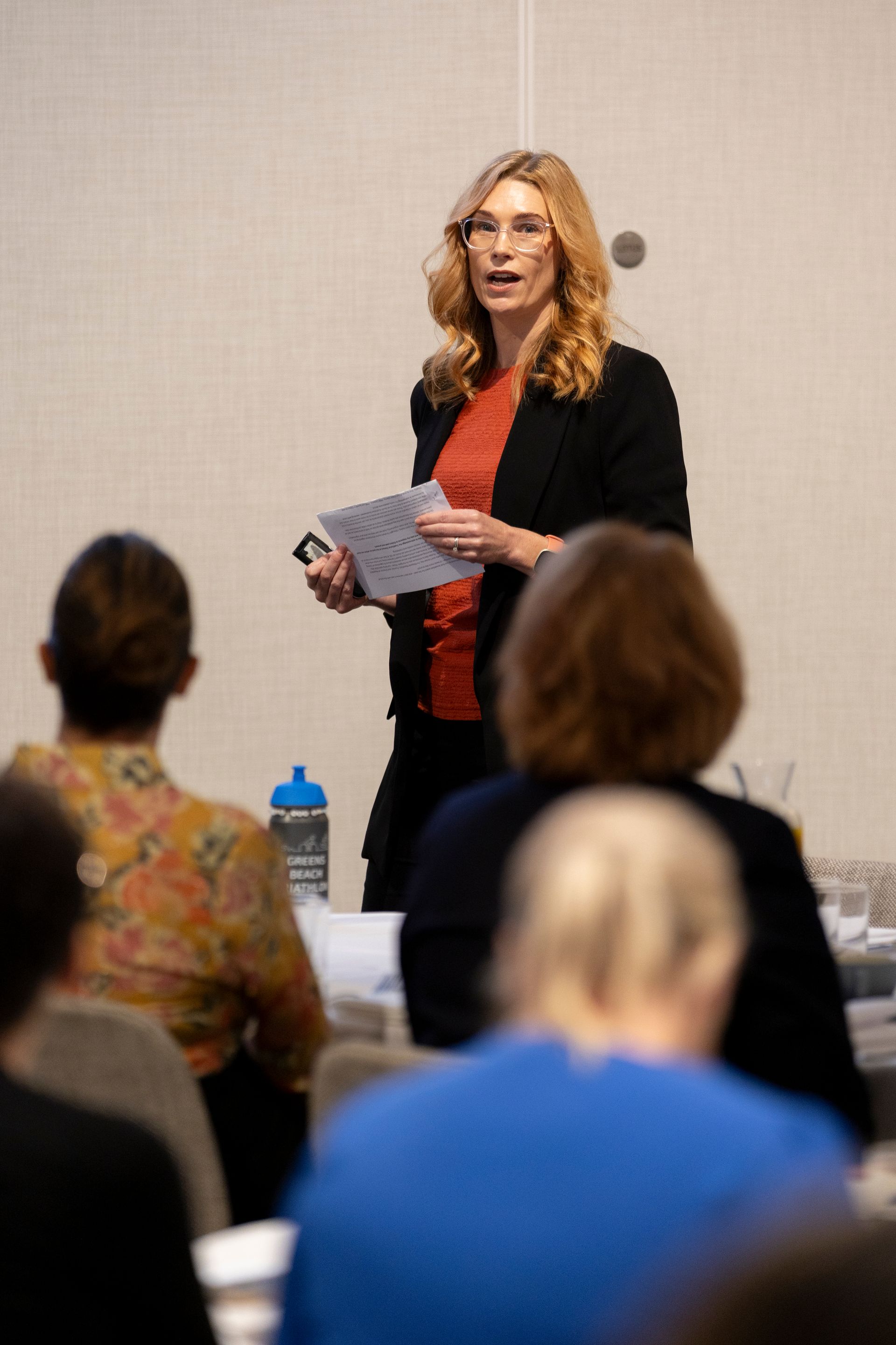 A woman is giving a presentation to a group of people.