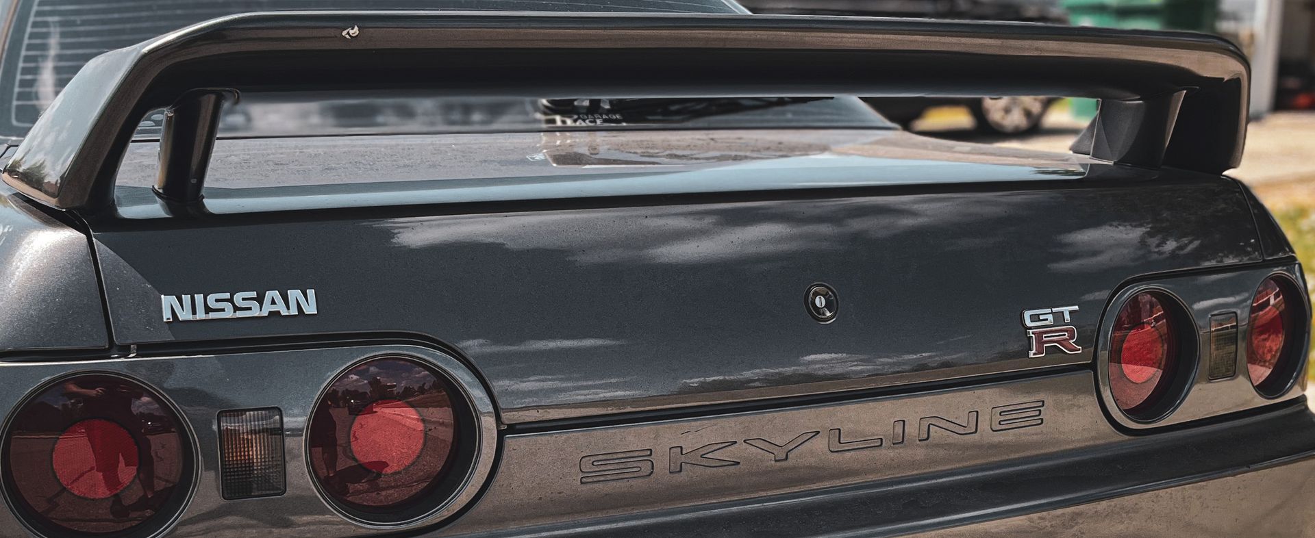 A black Nissan Skyline with a spoiler on the back