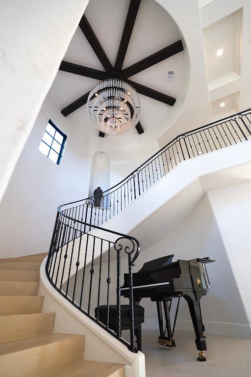 A staircase with a piano in the middle of it