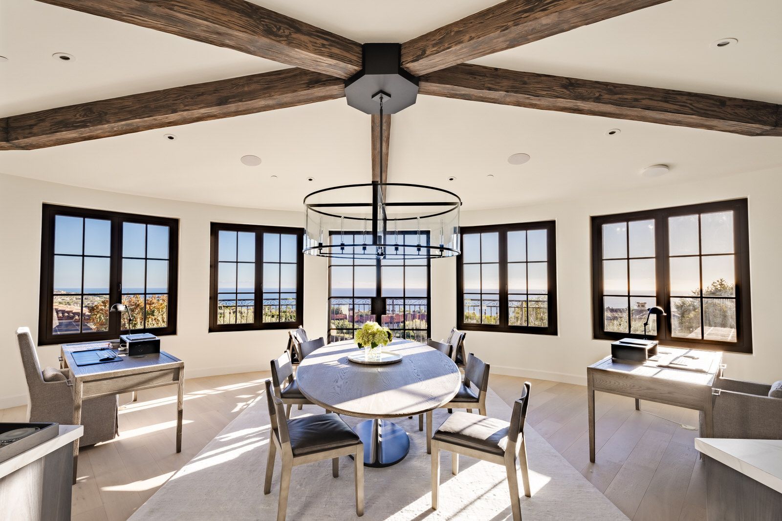 A large room with a round table and chairs