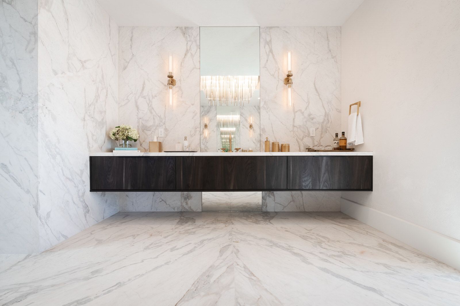 A bathroom with two sinks and a large mirror.