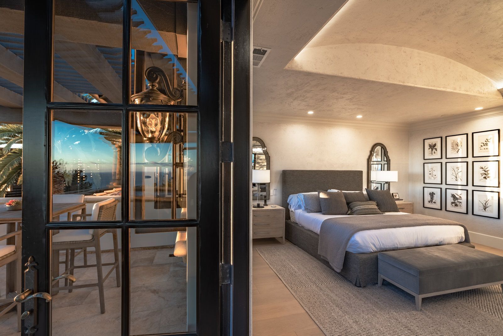 A bedroom with a large bed and a large window.