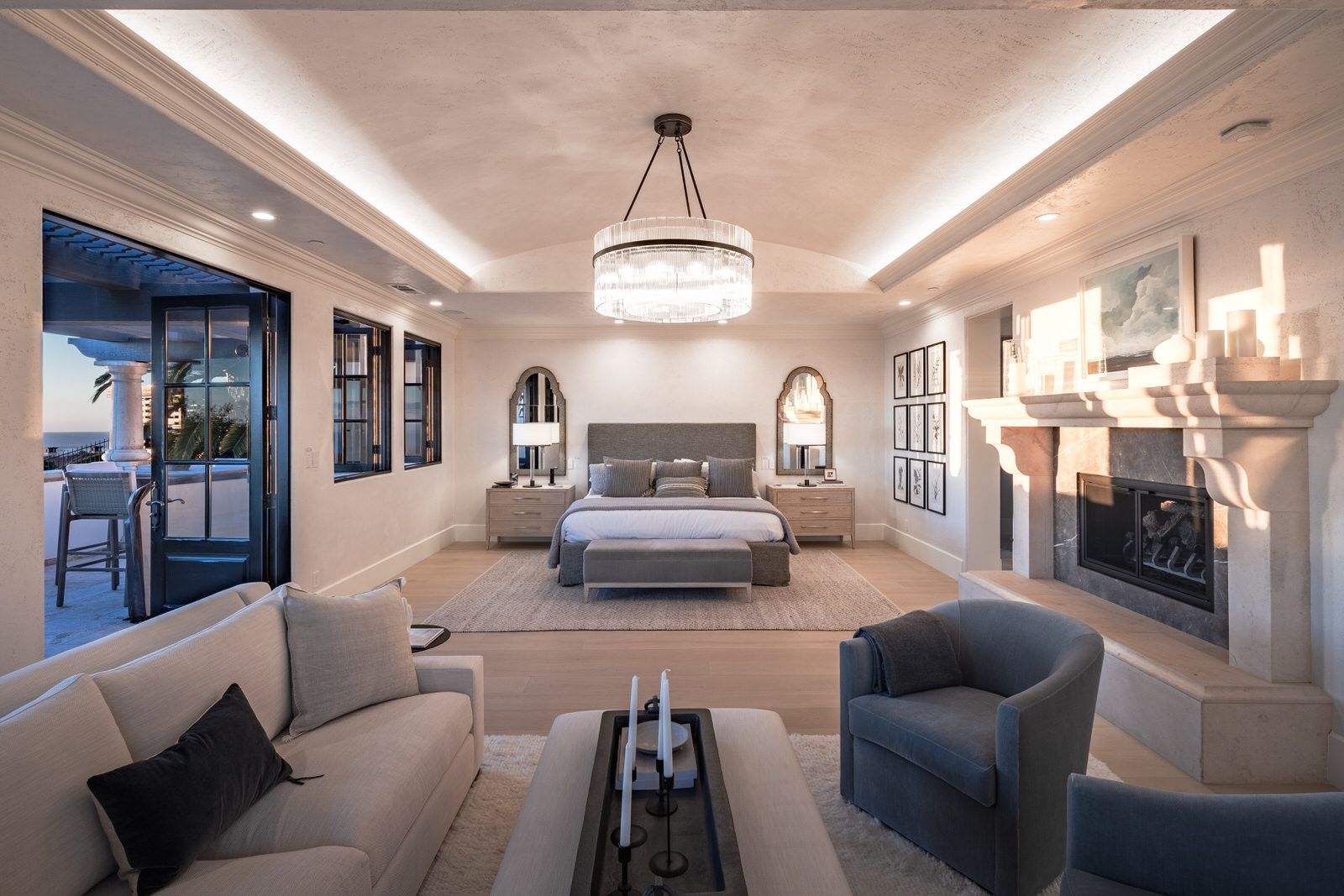 There is a large bedroom with a fireplace and a couch.