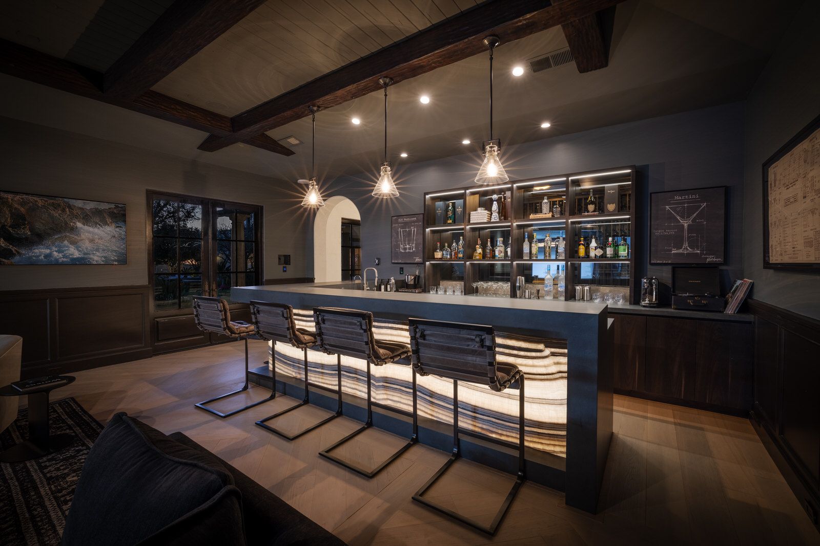 A bar with a row of bar stools in a living room.