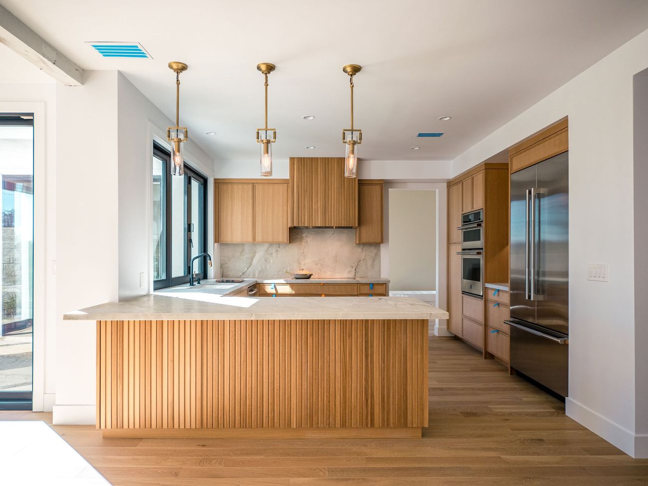 A kitchen with wooden cabinets and stainless steel appliances