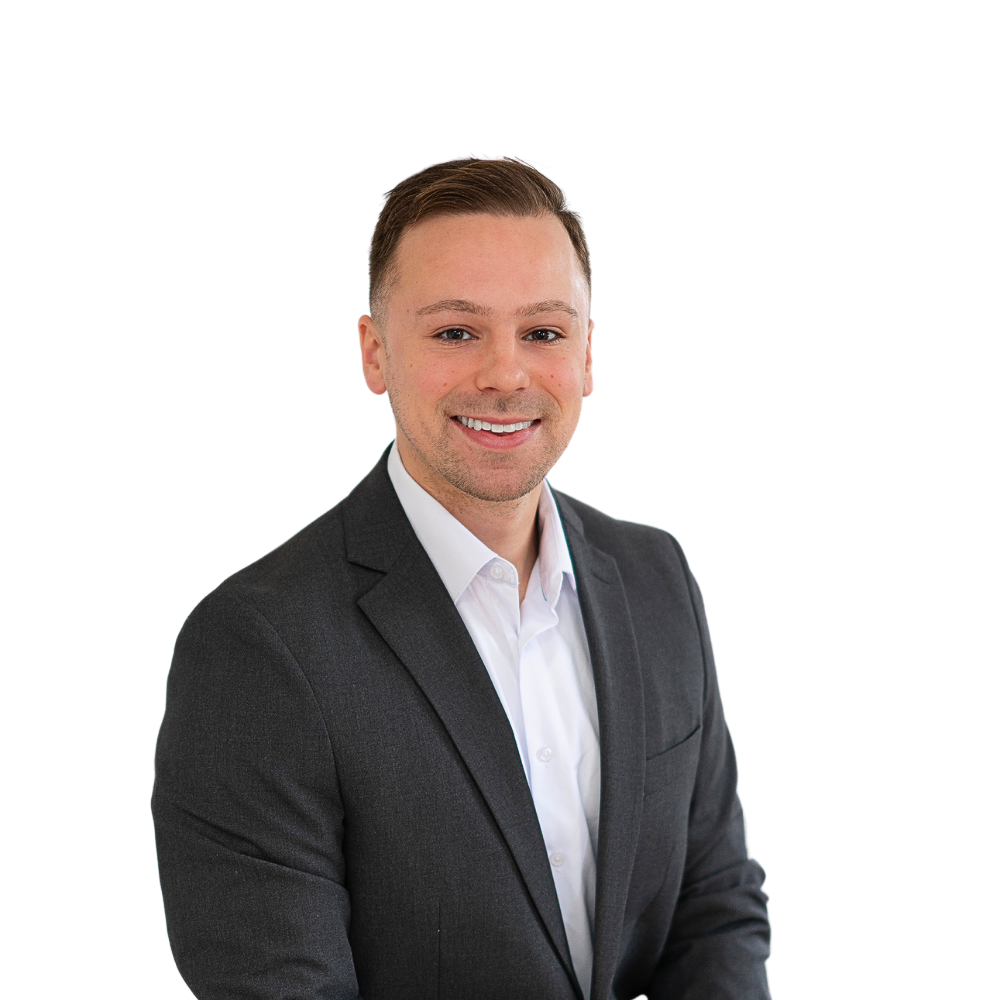 A man in a suit and white shirt is smiling for the camera