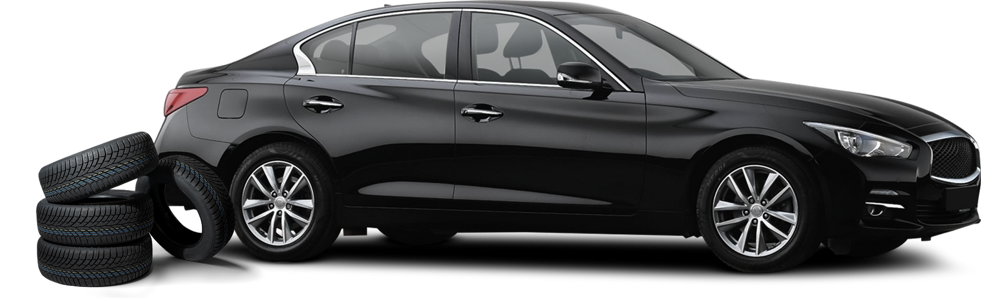 Black car with a stack of tires beside it.