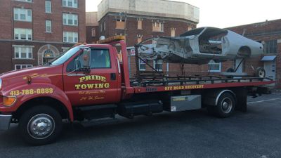 Free Junk Car Removal — Truck Towing A Car Frame in East Longmeadow, MA