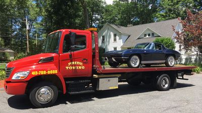 Towing Services — Truck Towing A Blue Car in East Longmeadow, MA