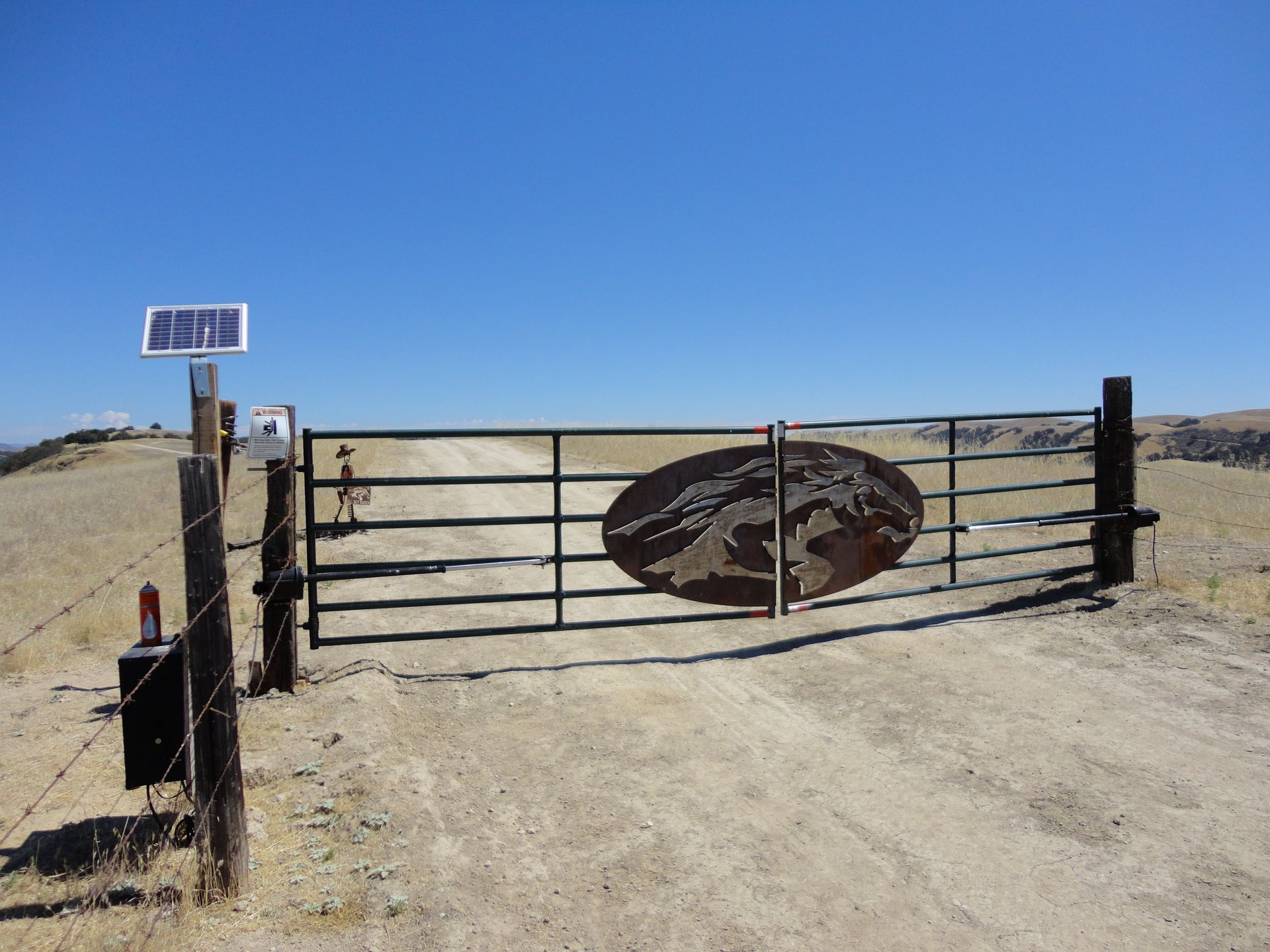 Custom Solar Entry Gate with center logo piece attached to gate.