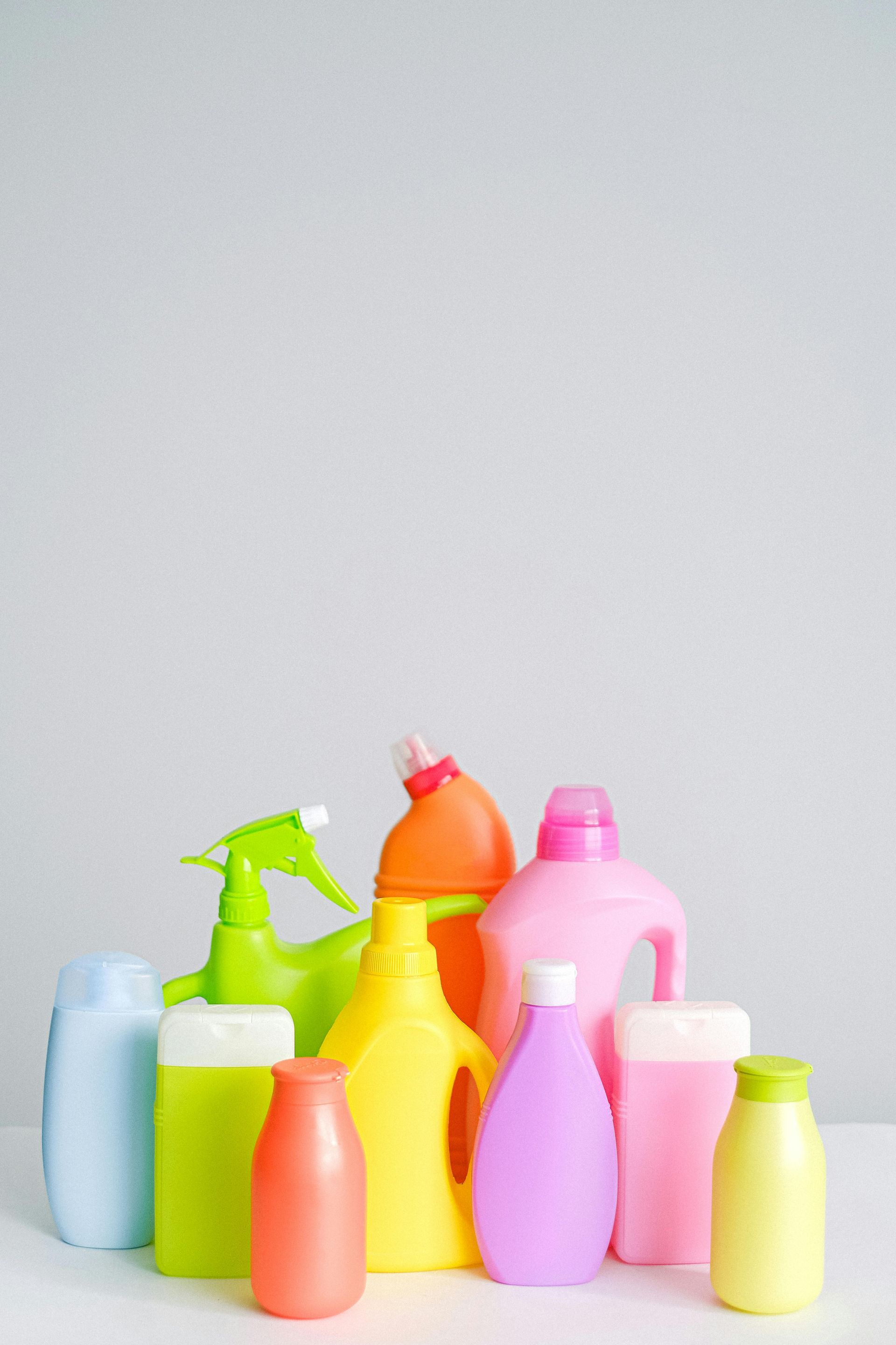 A group of colorful plastic bottles are sitting on a table.