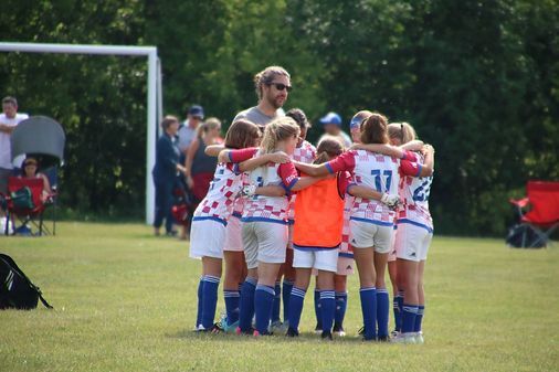 Croatian Eagles Soccer Club team huddled on the field