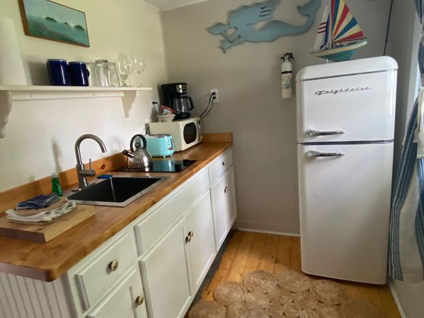 A small kitchen with a white refrigerator