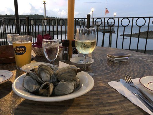Maine oysters and wine glasses overlooking Hull's Cove