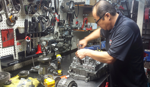 A man is working on a machine in a garage.
