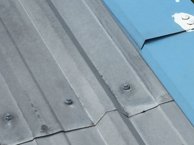 a close up of a metal roof with a blue trim