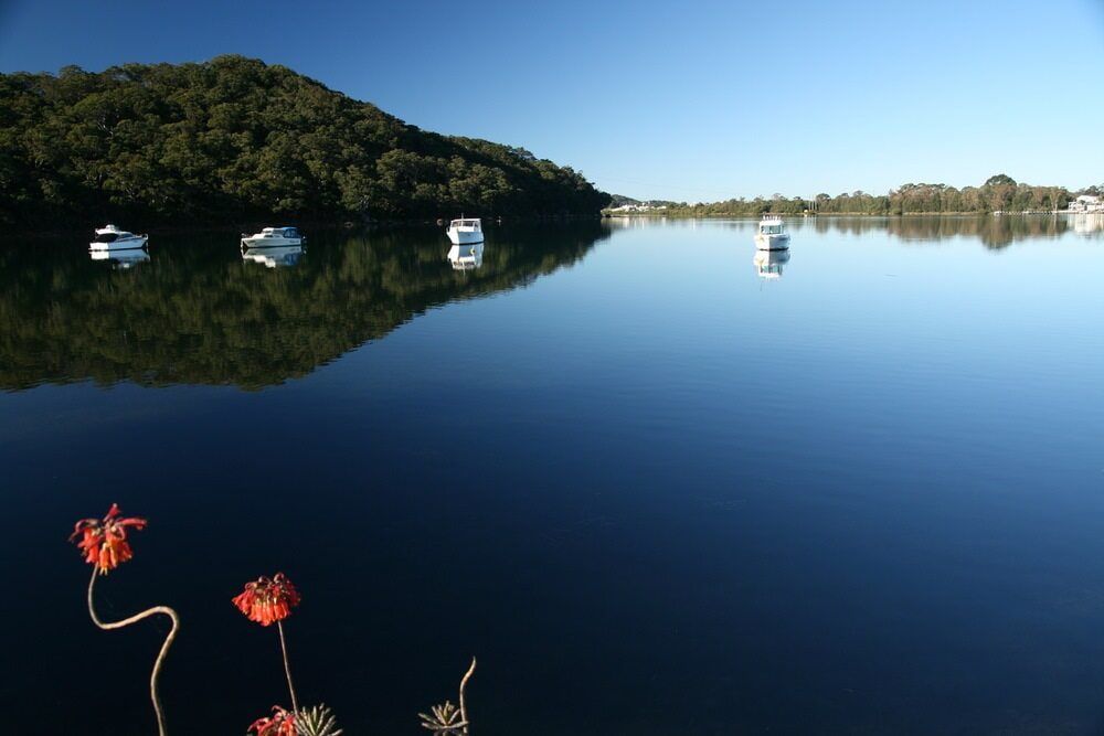 A Lake With Boats in It and a Mountain in the Background — ASpect Wall & Floor Tiling in Woy Woy, NSW