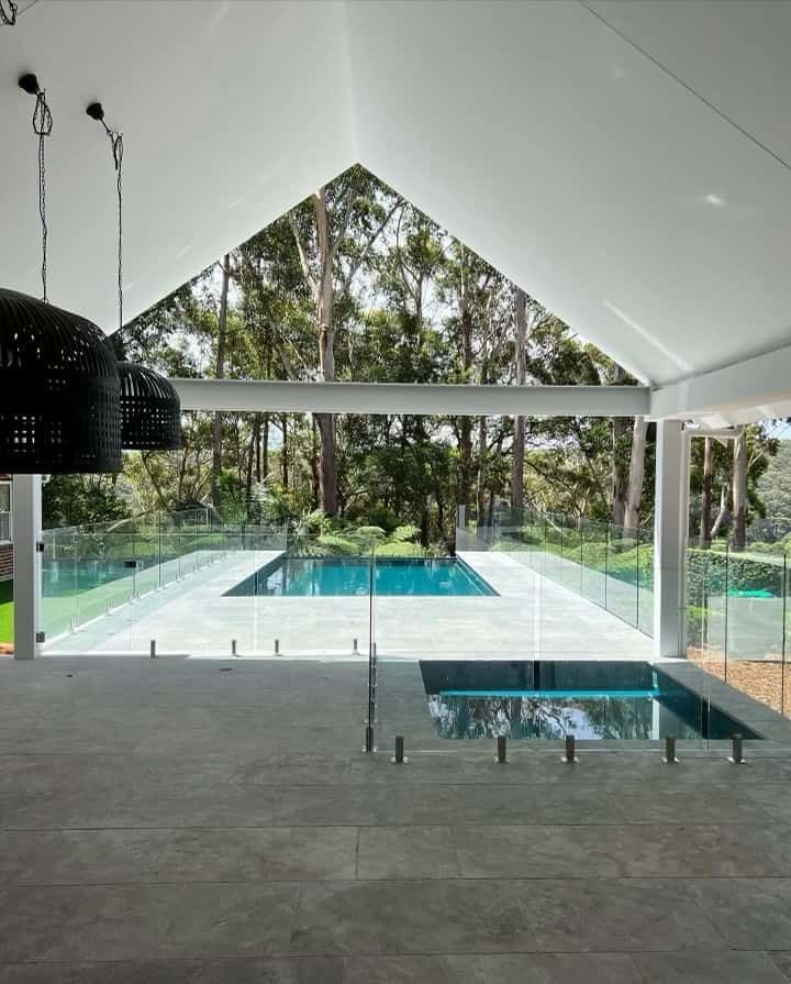 A House With a Swimming Pool and Trees in the Background — ASpect Wall & Floor Tiling in Charmhaven, NSW