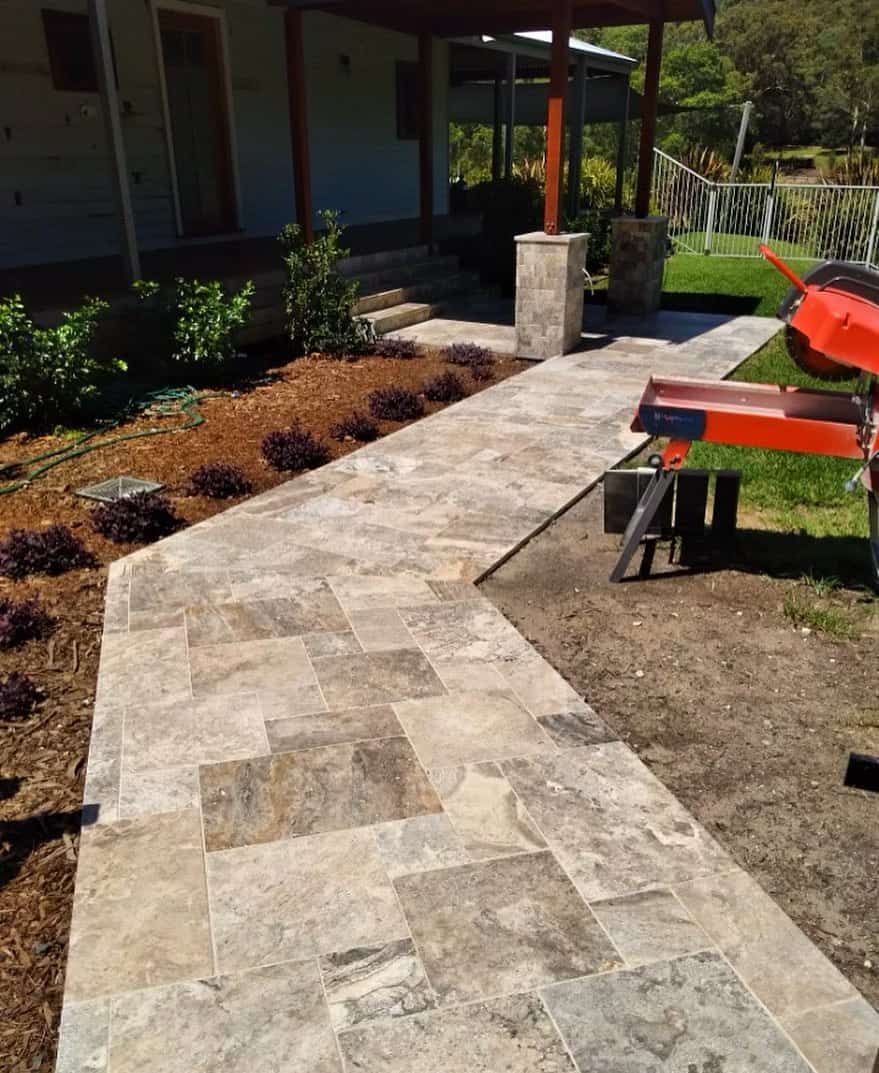 A Walkway is Being Built in Front of a House — ASpect Wall & Floor Tiling in Charmhaven, NSW
