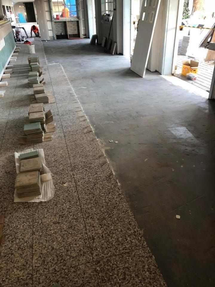 A Long Hallway With a Lot of Bricks on the Floor — ASpect Wall & Floor Tiling in Charmhaven, NSW