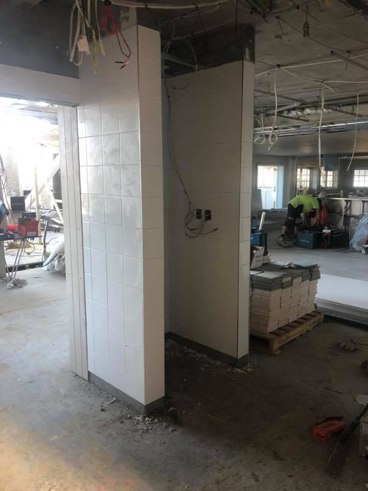 A Room is Being Remodeled in a Building With White Tiles on the Walls — ASpect Wall & Floor Tiling in Gosford, NSW