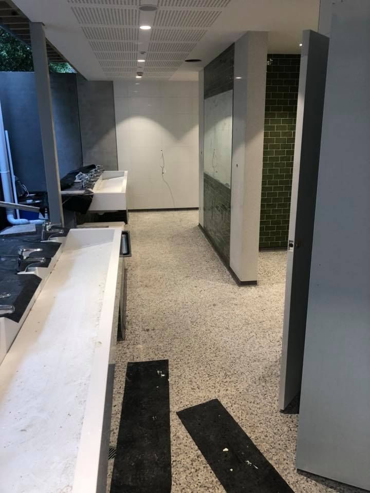 A Long Hallway Leading to a Bathroom With a Sink — ASpect Wall & Floor Tiling in Gosford, NSW