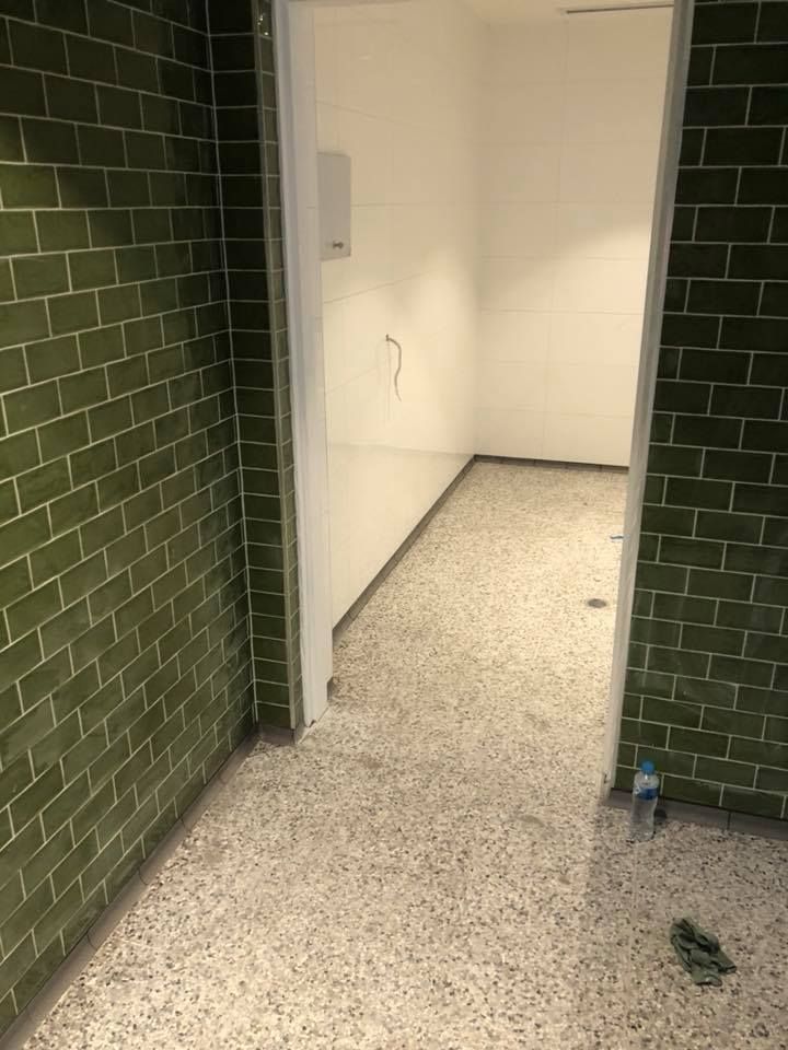 A Hallway With Green Tiles on the Walls and a White Floor — ASpect Wall & Floor Tiling in Woy Woy, NSW