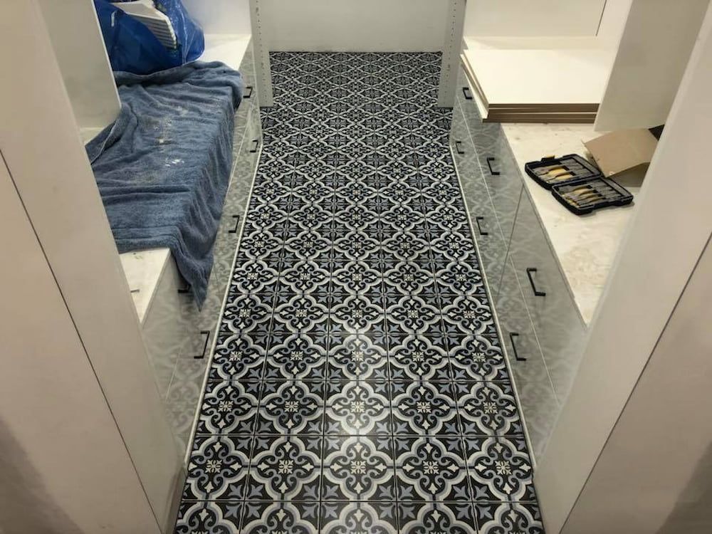 A Long Hallway With Black And White Tiles On The Floor — ASpect Wall & Floor Tiling in Taree, NSW