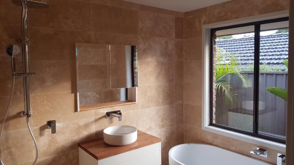 A Bathroom With a Sink , Tub , Shower and Mirror — ASpect Wall & Floor Tiling in Toukley, NSW