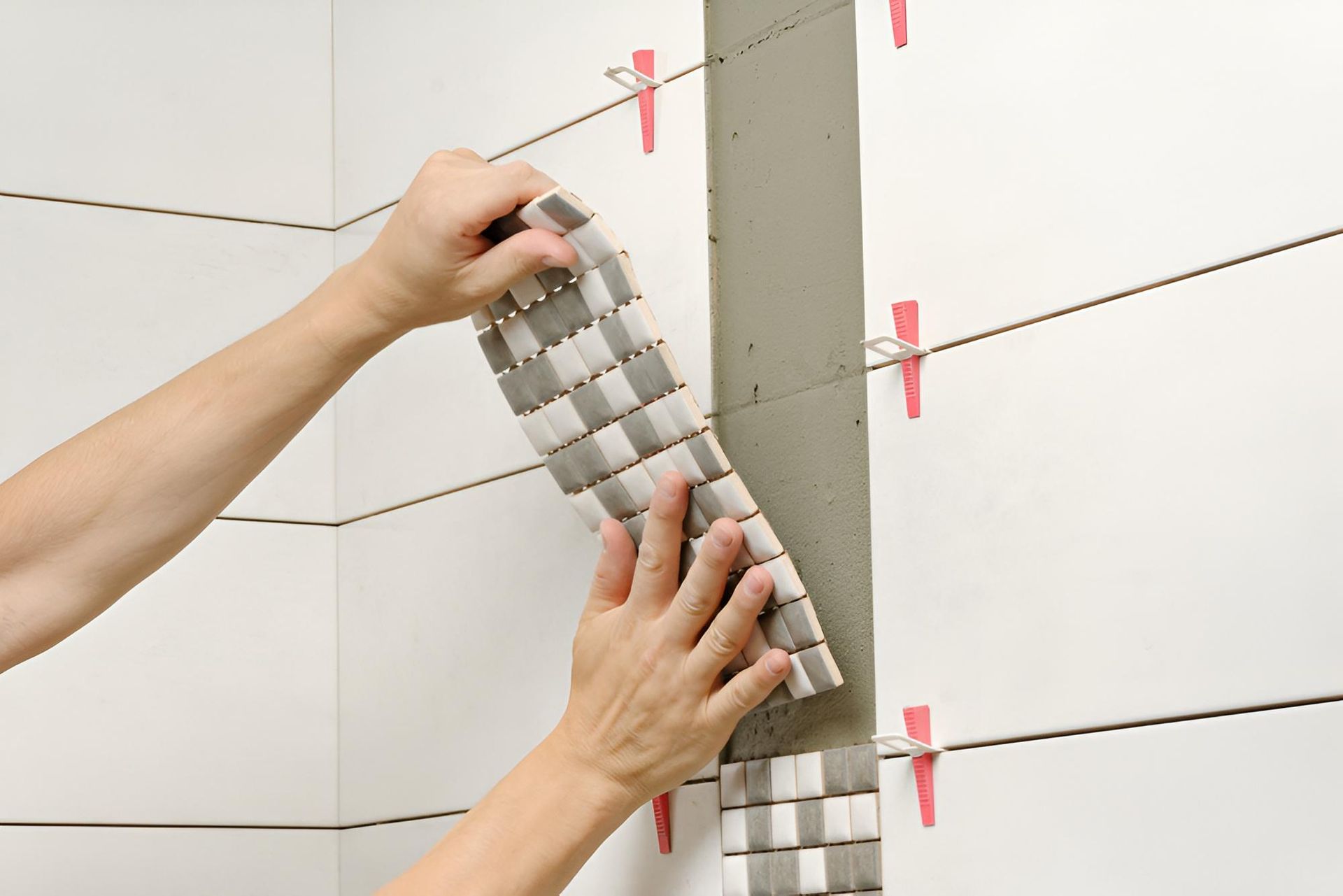 Person Tiling a Wall With Mosaic Tiles — ASpect Wall & Floor Tiling in Port Macquarie, NSW