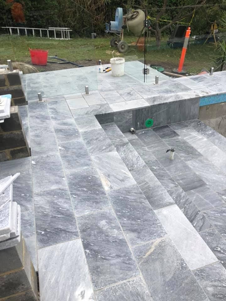 A Swimming Pool is Being Built With Tiles and Stairs — ASpect Wall & Floor Tiling in Toukley, NSW