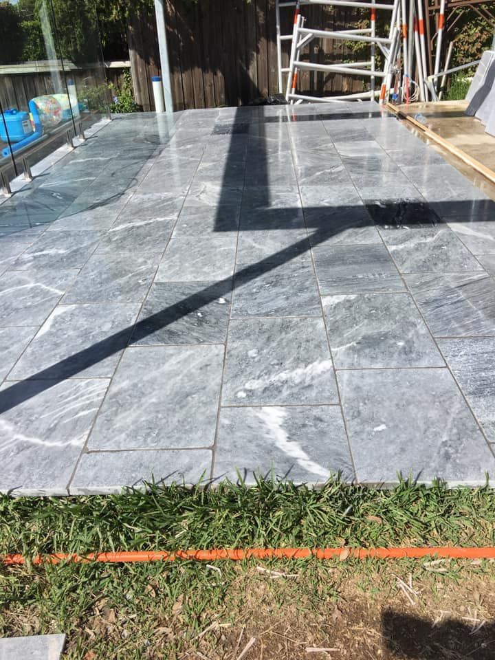 A Patio With Tiles and a Scaffolding in the Background — ASpect Wall & Floor Tiling in Charmhaven, NSW