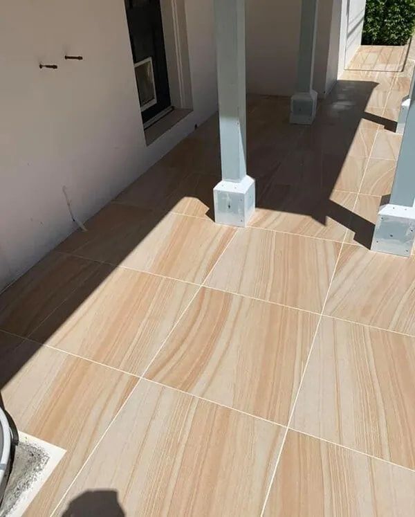 A Tiled Floor With a White Pillar in the Background — ASpect Wall & Floor Tiling in Wyong, NSW