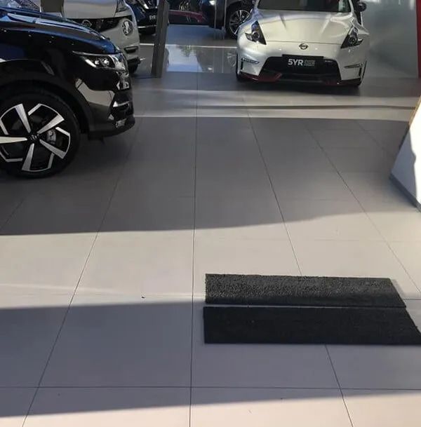 A Black Car is Parked Next to a White Car — ASpect Wall & Floor Tiling in Charmhaven, NSW