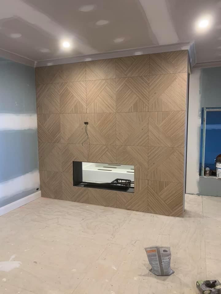 A Living Room With a Fireplace in the Middle of the Wall — ASpect Wall & Floor Tiling in Hunter Valley, NSW