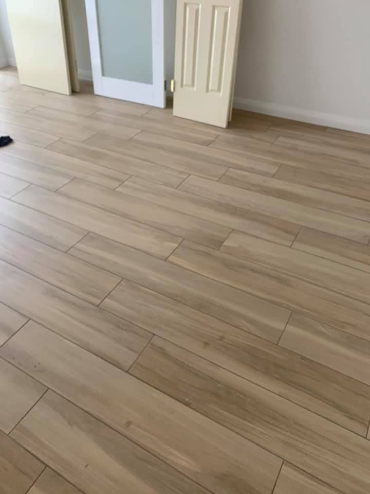 A Room With a Wooden Floor and a White Door — ASpect Wall & Floor Tiling in Erina, NSW