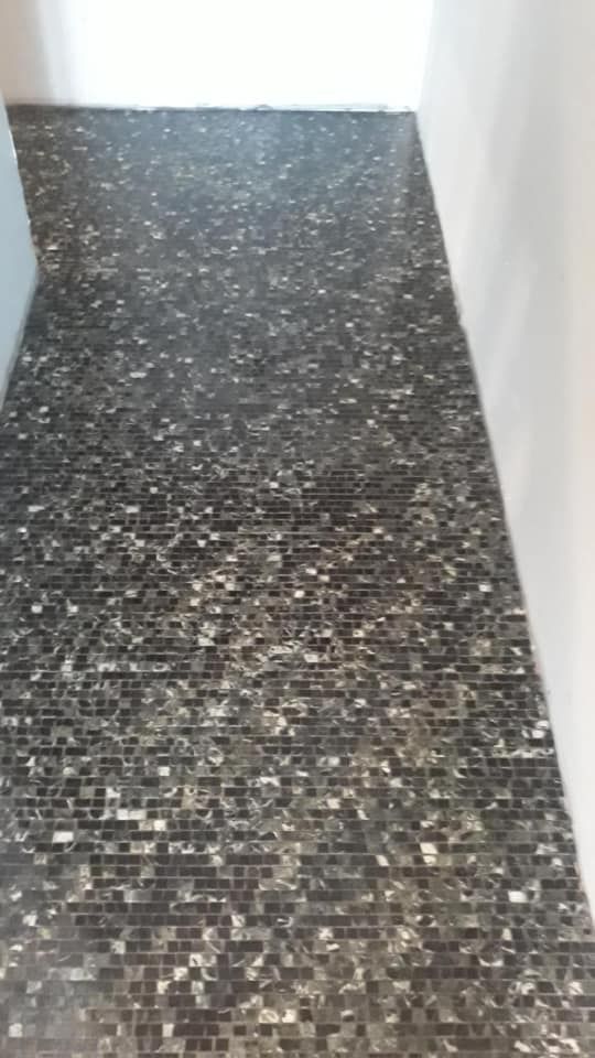 A Black and White Tile Floor in a Hallway — ASpect Wall & Floor Tiling in Hunter Valley, NSW