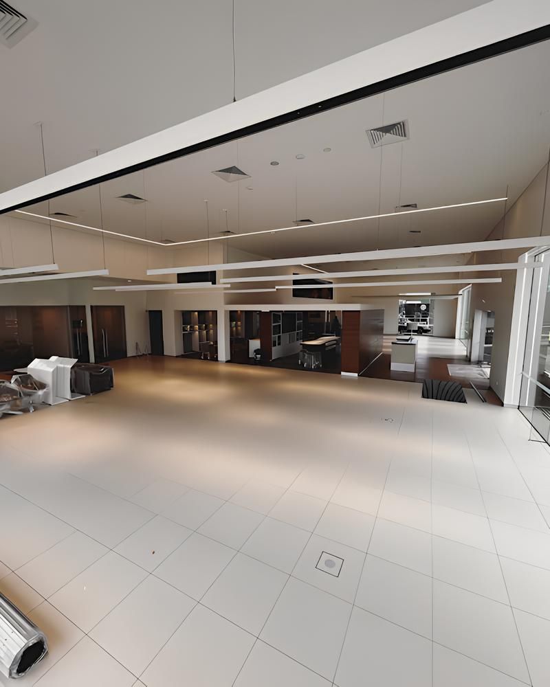 A Large Empty Room With a Lot of Windows and Furniture — ASpect Wall & Floor Tiling in Charmhaven, NSW