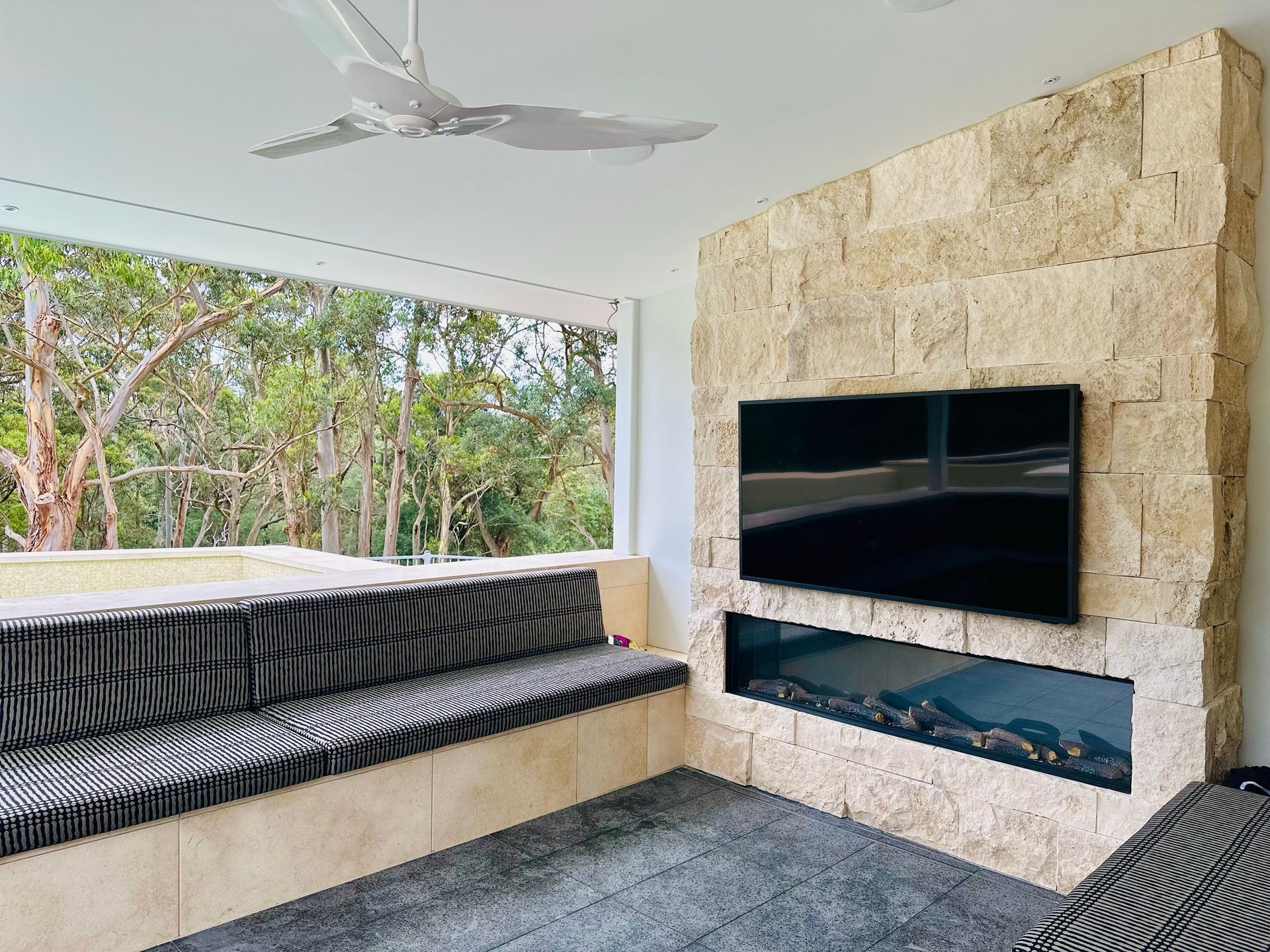 A Living Room With a Fireplace and a Flat Screen Tv on the Wall β ASpect Wall & Floor Tiling in Charmhaven, NSW