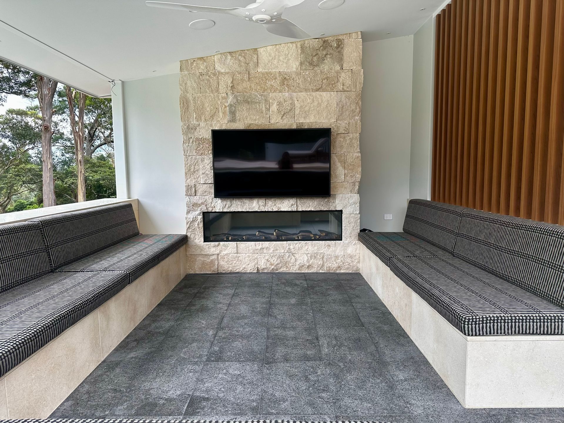 A Living Room With a Fireplace and a Flat Screen TV β ASpect Wall & Floor Tiling in Charmhaven, NSW