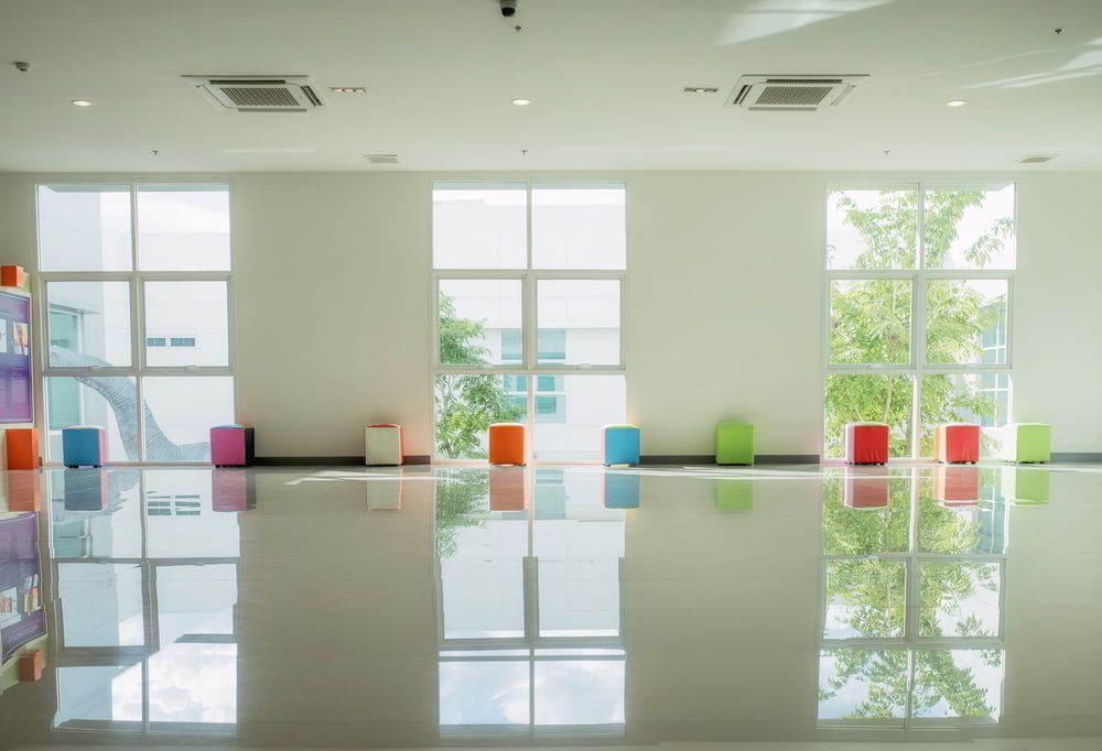 A Large Room With a Lot of Windows and Colourful Ottomans — ASpect Wall & Floor Tiling in Charmhaven, NSW