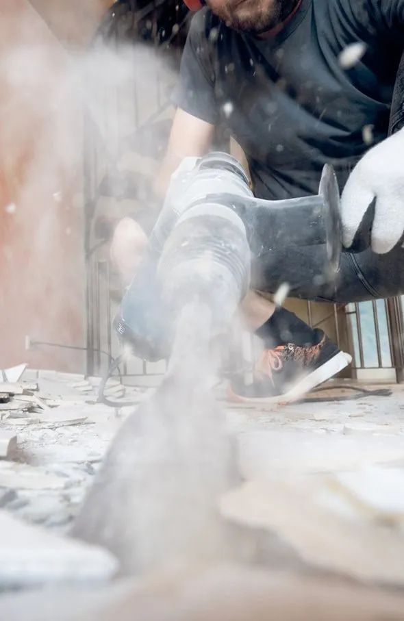 A Long Hallway With a Tiled Floor and a Brick Wall — ASpect Wall & Floor Tiling in Charmhaven, NSW