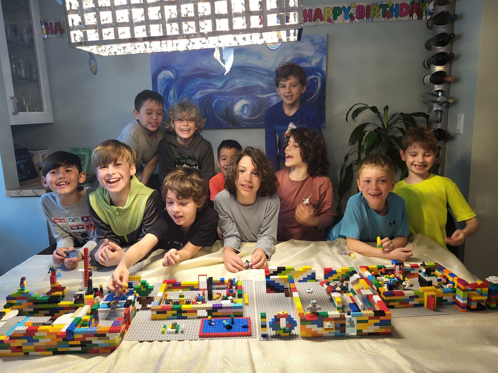 A boy and a girl are playing with colorful lego blocks.