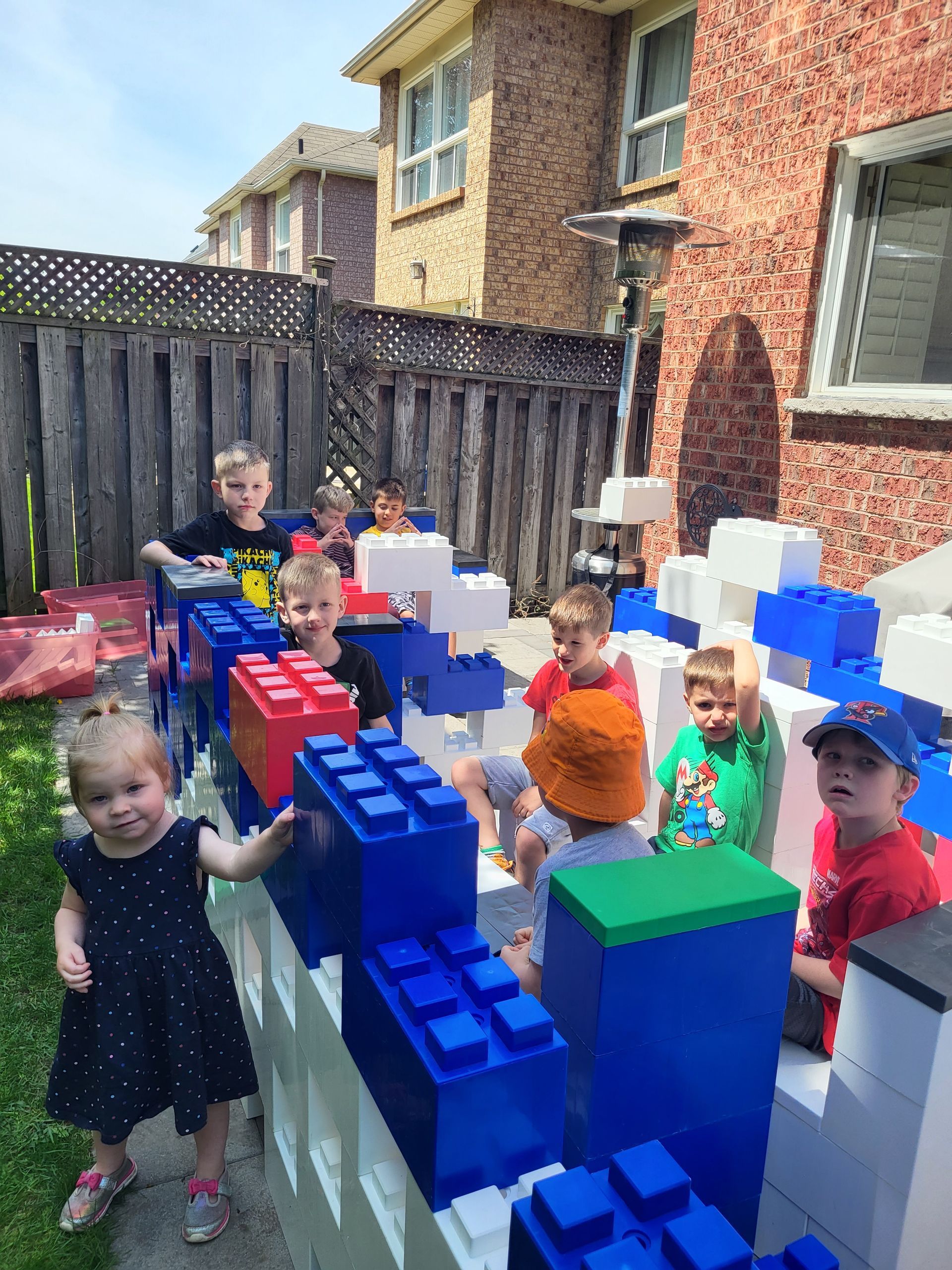 A group of children wearing party hats and holding balloons at a birthday party.