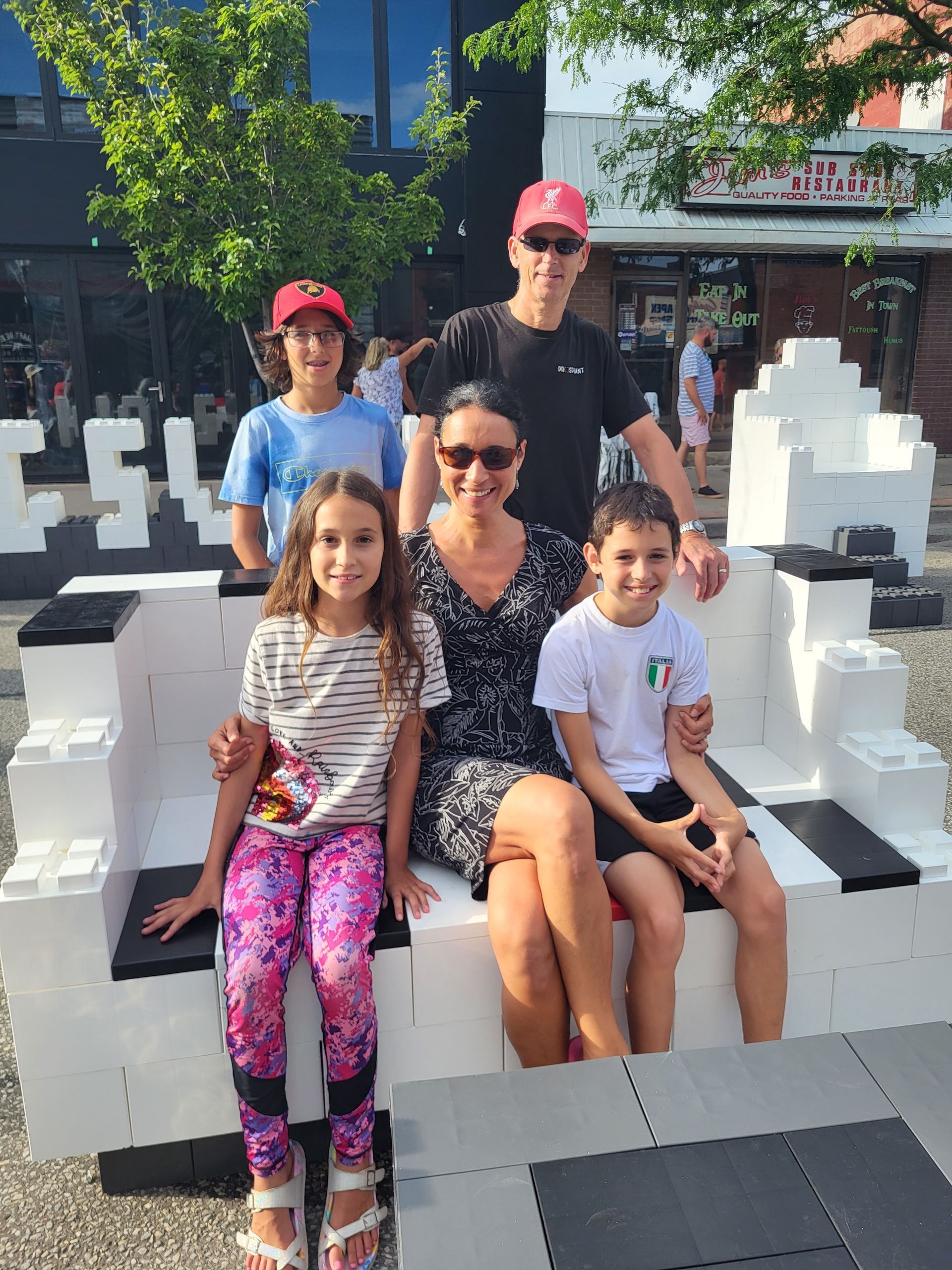 A man and a boy are playing with legos on the floor.