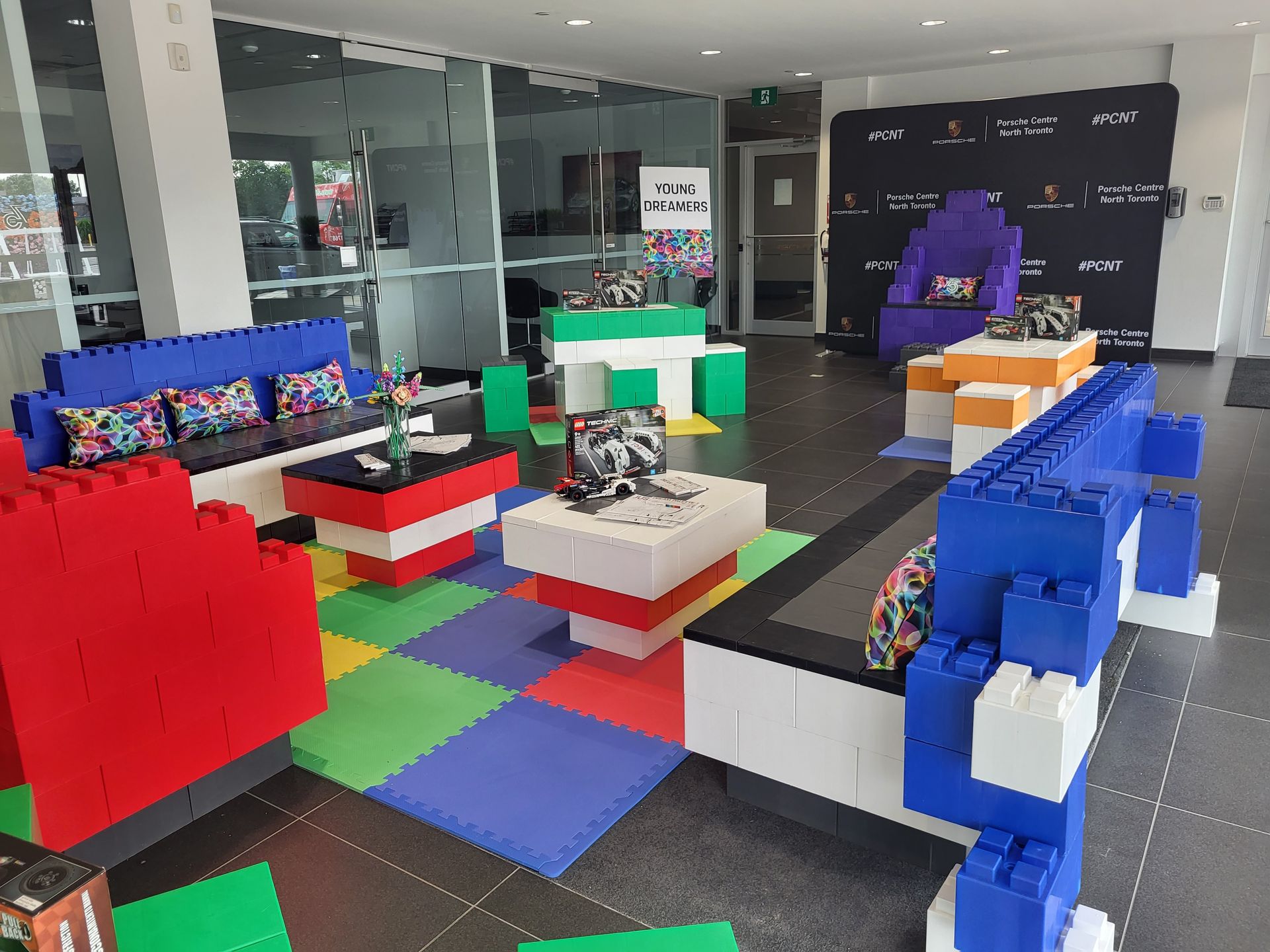 A group of children wearing party hats and holding balloons at a birthday party.